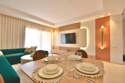 a living room with a table with plates on it at Noria Residence - Premium 2BR Apartment with Pool View in Marrakech
