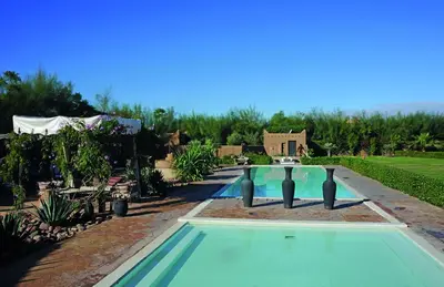 a swimming pool in a yard with a house at Fawakay Villas in Sfiani