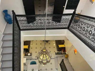 an overhead view of a staircase with a chandelier at Ryad Lalla khadija in Marrakech