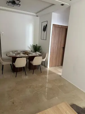 a dining room with a table and chairs and a door at Appartement cosy à Marrakech in Marrakech