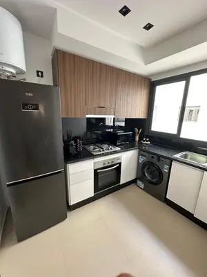 a kitchen with a stainless steel refrigerator and a dishwasher at Appartement cosy à Marrakech in Marrakech