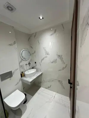 a white bathroom with a toilet and a sink at Appartement cosy à Marrakech in Marrakech