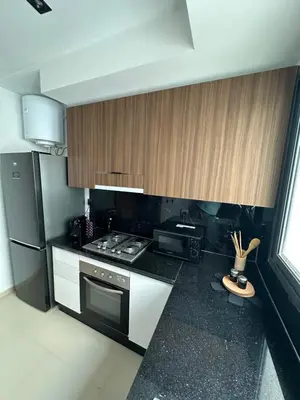 a kitchen with a stove and a refrigerator at Appartement cosy à Marrakech in Marrakech