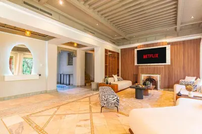 a living room with a couch and a fireplace at Luxurious villa Marrakech La Palmeraie in Marrakech