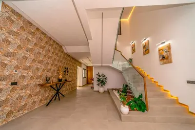 a hallway with stairs and a tile wall at Villa Lumeria in Marrakech