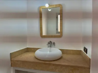 a sink in a bathroom with a mirror at Charmante villa avec piscine privée et jardin in Marrakech