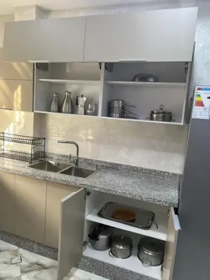 a kitchen with a sink and a counter at Appartement Abdessamad Hébergement réservé aux familles in El Gouassem