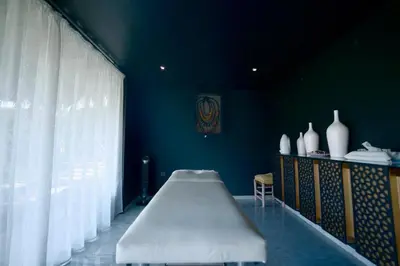 a blue room with a bed and vases on a table at Royal Palm Luxury Villa Heated Pool Spa in Moussiha