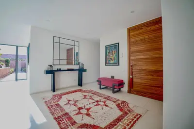 a living room with a red bench and a door at Royal Palm Luxury Villa Heated Pool Spa in Moussiha