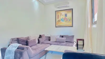 a living room with a purple couch and a table at Cycas family apart ground floor parking in Marrakech