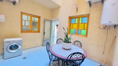 a patio with a table and a washing machine at Cycas family apart ground floor parking in Marrakech