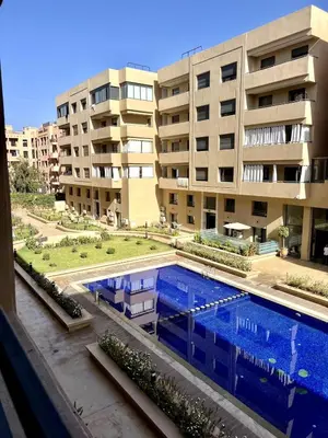 a large swimming pool in front of a building at Palmeraie Gates 2 chambres Piscine et Parking in Marrakech