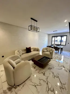 a living room with two couches and a table at Palmeraie Gates 2 chambres Piscine et Parking in Marrakech