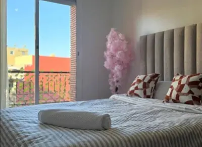a bedroom with a bed with a large window at Maison LINA in Marrakech