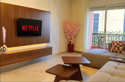 a living room with a couch and a tv at Maison LINA in Marrakech