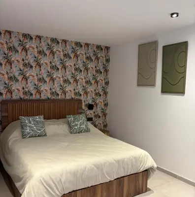 a bed with two pillows on it in a bedroom at Villa 5 suites piscine privée in Marrakech