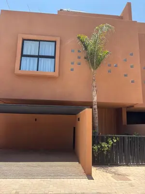 a palm tree in front of a house at Villa 5 suites piscine privée in Marrakech