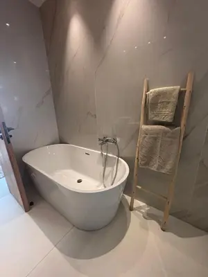 a white bath tub in a bathroom with a ladder at Villa 5 suites piscine privée in Marrakech