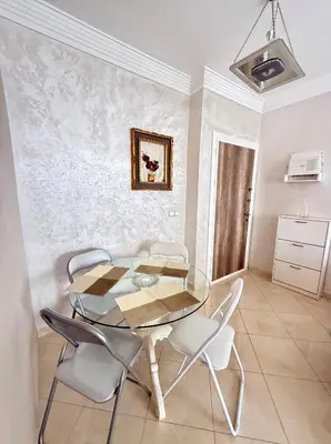 a dining room with a glass table and chairs at Layla Apartment in Marrakech