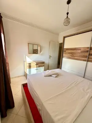 a bedroom with a white bed in a room at Layla Apartment in Marrakech
