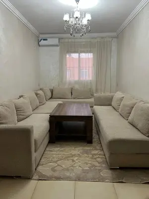 a living room with a couch and a coffee table at Appartement bien équipé avec piscine sur Marrakech in Marrakech