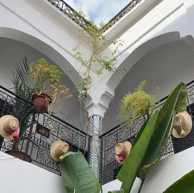 a balcony with potted plants on a railing at Riad Sijane in Marrakech