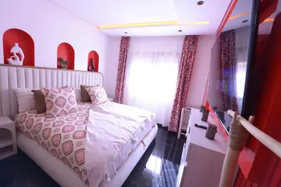 a bedroom with a white bed and a window at Appartement Spacieux Idéal Séjours Longs in Marrakech