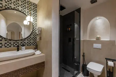a bathroom with a toilet and a sink and a mirror at Cosy escape 1BED in central Gueliz With Pool in Marrakech
