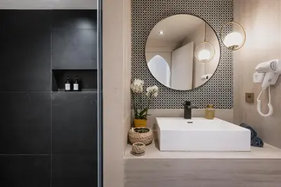 a bathroom with a white sink and a mirror at City Center 1 BED Apartments - Miramas - Pool and gym in Marrakech