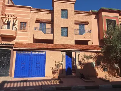 a building with blue doors on the side of it at charming place in Marrakech