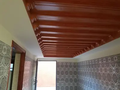 a wooden ceiling in a room with a window at charming place in Marrakech