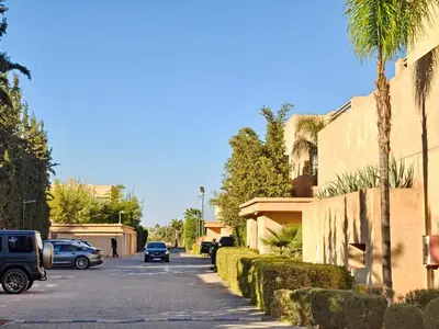 a street with cars parked on the side of a building at Duplexe Moderne 2 suites è Oliver Palm Resort in Marrakech