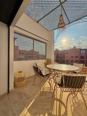 a patio with a table and chairs on a balcony at Premium Stay in a Prestigious Residence with a Pool in Marrakech
