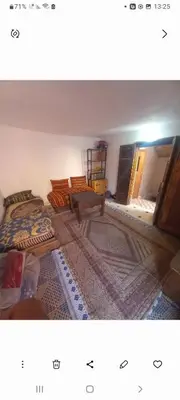 a living room with two beds and a rug at Madam Laila house in Marrakesh in Marrakech
