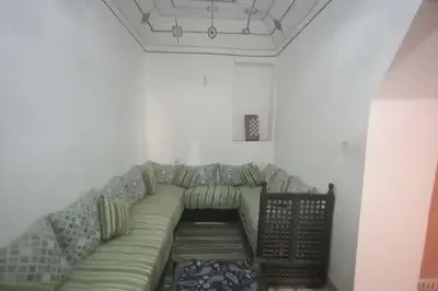 a living room with a green couch in a room at Madam Laila house in Marrakesh in Marrakech