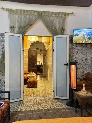 a room with a door open to a living room at Riad Dar Ceramic in Marrakech