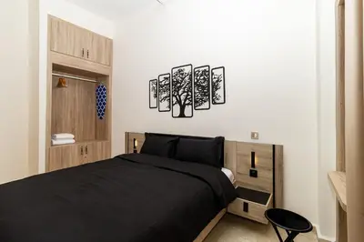 a bedroom with a bed and three lights on the wall at Karim Miloudi in Marrakech