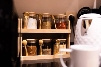 a wooden shelf with jars and spoons on it at Karim Miloudi in Marrakech