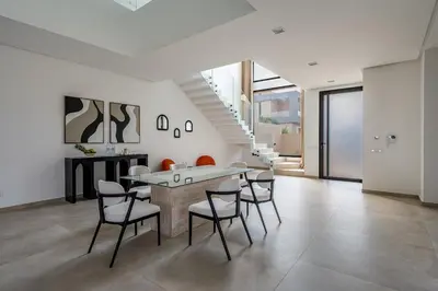 a dining room with a table and chairs at Villa LUMA - Akenza Residence in El Rhechat