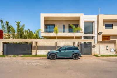 a small blue car parked in front of a building at Villa LUMA - Akenza Residence in El Rhechat