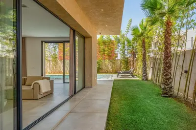 an internal view of a house with a garden at Villa LUMA - Akenza Residence in El Rhechat