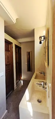 a bathroom with a sink and a tub with at Freedom Yan Hostel in Marrakech