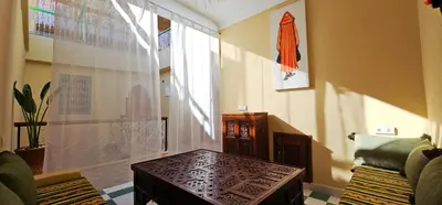 a living room with a table and a window at Freedom Yan Hostel in Marrakech