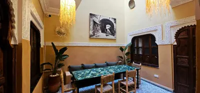 a dining room with a table and chairs at Freedom Yan Hostel in Marrakech