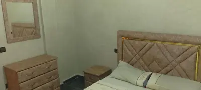 a bedroom with a bed and a dresser and a mirror at Belkadi in Marrakech