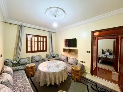 a living room with a couch and a table at Appartement Kech in Marrakech
