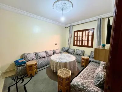 a living room with a couch and a table at Appartement Kech in Marrakech
