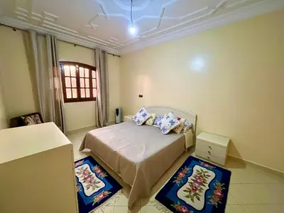 a bedroom with a bed with two pillows on it at Appartement Kech in Marrakech