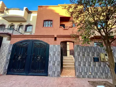 a house with a blue gate in front of it at Appartement Kech in Marrakech