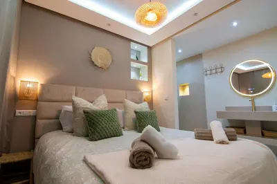 a bedroom with a large bed and a mirror at Victor Hugo Prestige Suite in Marrakech